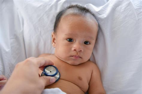 premium photo cropped hand checking baby  bed