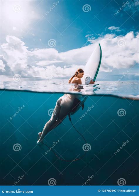 Naked Surf Girl with Surfboard in Blue Ocean. Freedom and Surfing Stock