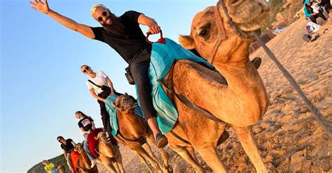 Tangier: Achakar Beach Sunset Camel Ride & Moroccan Dinner | GetYourGuide