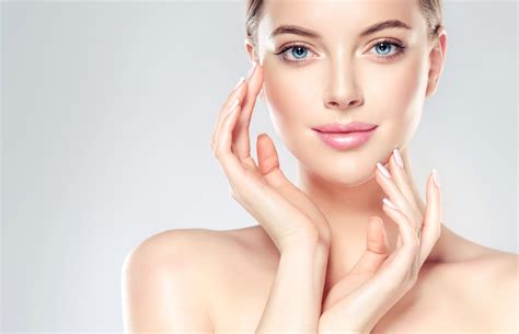 Beautiful Young Woman with Clean Fresh Skin touch own face . Facial ...