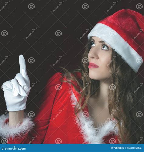Attractive Woman Dressed Santa Hat Pointing at Copy Space Stock Photo