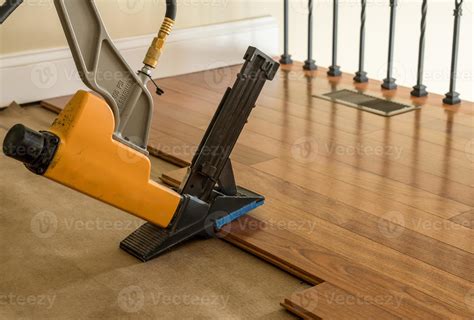 High pressure nail gun ready to install sections of Brazilian Cherry