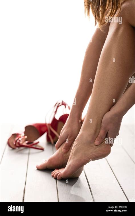 Barefoot Woman with High Heels on Floor Stock Photo - Alamy