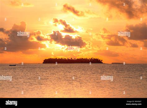 Sunset over tropical island, Maldives Stock Photo - Alamy