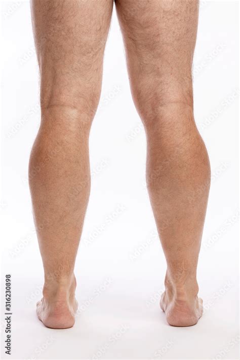 Bare hairy male legs on a white background. Close-up. Stock Photo ...