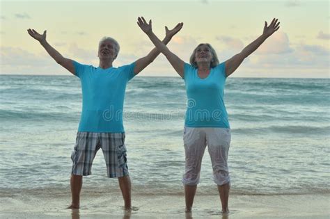 Happy Elderly Couple Resting on Tropical Beach Stock Photo - Image of ...