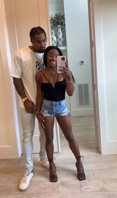 Simone Biles Snaps A Mirror Selfie in Barely-There Heels & Lacy Dress