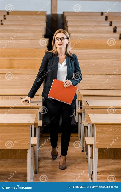 female university professor  formal wear holding journal