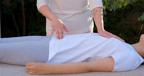 Woman do traditional chinese massage outdoors in summer garden 7666338
