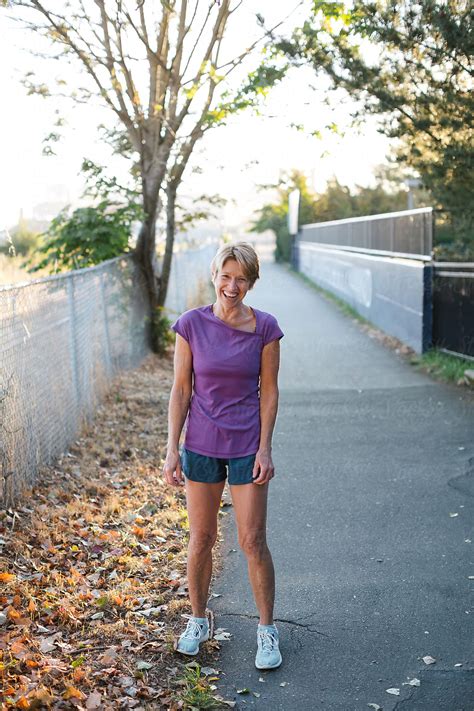 "Healthy Mature Woman On Urban Morning Run" by Stocksy Contributor "Rob
