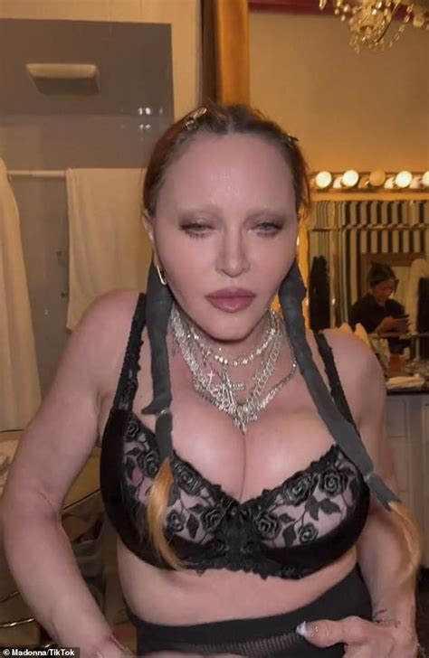 madonna  poses topless  biting   balenciaga purse