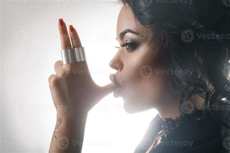 half face photo of Beauty woman on grey background suck finger 16540223