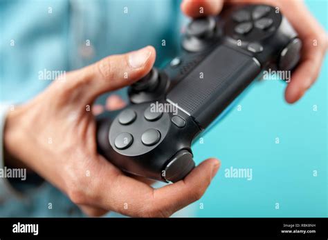 male hands holding  gaming controller stock photo alamy