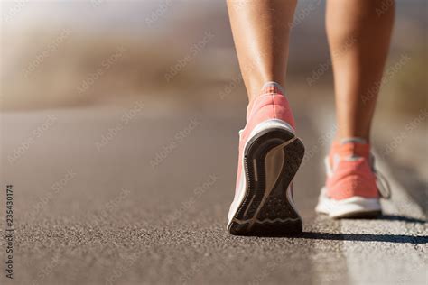 Running shoe closeup of woman running on road with sports shoes Stock ...