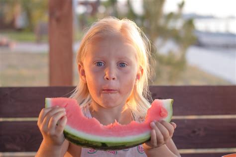 funny kid girl eat watermelon slices 7713648 Stock Photo at Vecteezy