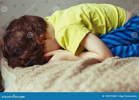 Tired Toddler Boy Lying on the Bed with His Face Down. Crying Little ...