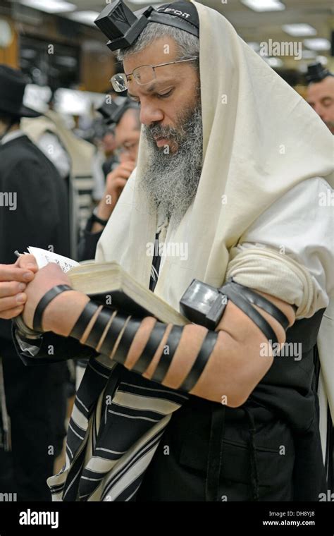 Religious Jewish man praying wearing tefillin, phylacteries, and a ...