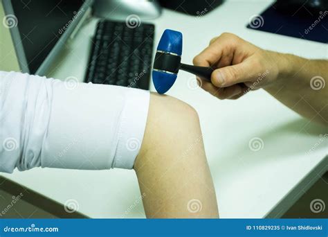 Neurological Examination. The Neurologist Testing Reflexes On A Female ...