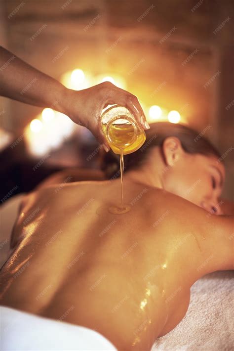 Premium Photo | Body oil back massage and masseuse with woman at spa