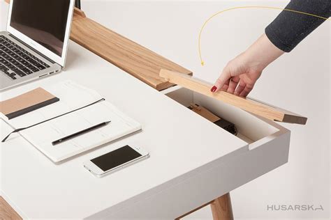 This home office desk comes with hidden storage systems to keep your ...