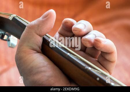 Guitarist fingers calluses with acoustic guitar fretboard Stock Photo - Alamy