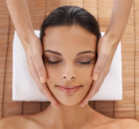 Whole-body Care. a Young Woman Enjoying a Head and Face Massage at a ...