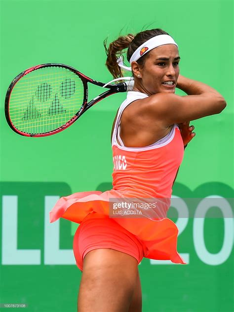 Puerto Rico's Monica Puig returns the ball to Colombian player