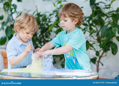 Two Adorable Boys Making Experiment with Colorful Bubbles Stock Image