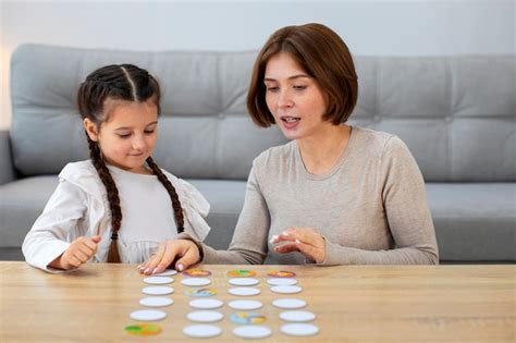Free Photo | Mother and girl playing game front view