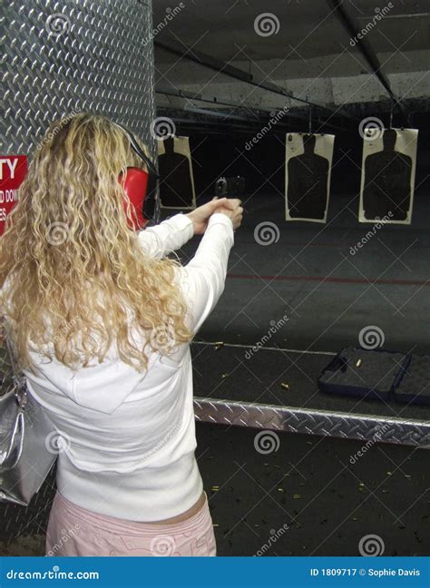 Woman shooting a gun stock image. Image of concentration - 1809717