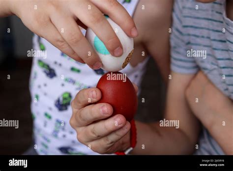 childrens hands knocking easter eggs outdoor traditional egg fight