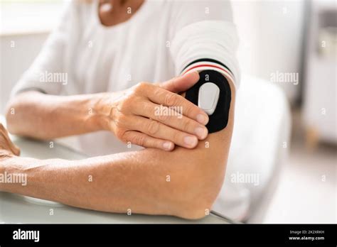 Woman Testing Glucose Level With A Continuous Glucose Monitor Stock Photo - Alamy