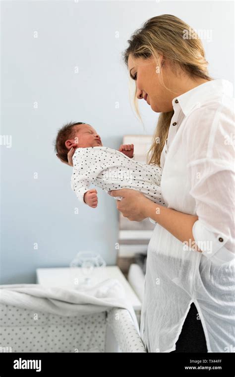 Mother holding her newborn baby Stock Photo - Alamy