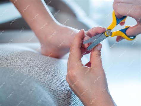 Premium Photo | Cut the toenails of a child