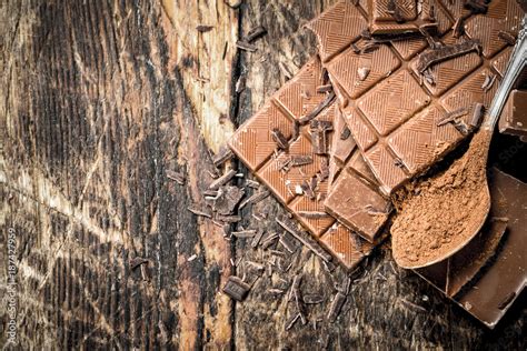 Chocolate bars with cocoa powder. Stock Photo | Adobe Stock