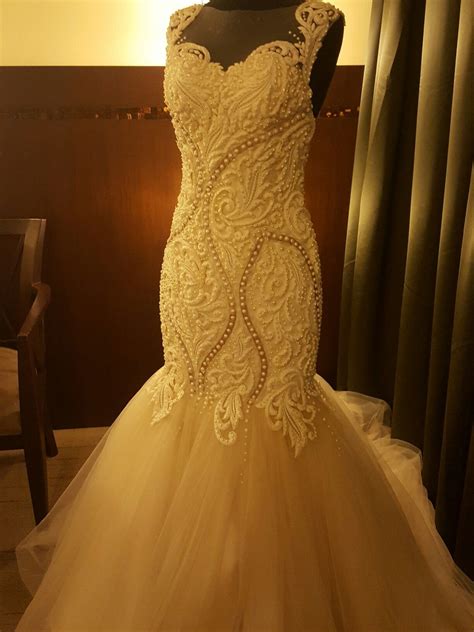 elegant serpentine wedding gown  intricate lace detail