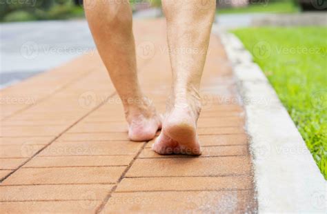 senior man barefoot walking on bricks walkway in the park 31400132 ...