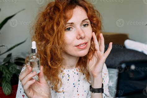 Young curly redhead female blogger filming daily tutorial for social