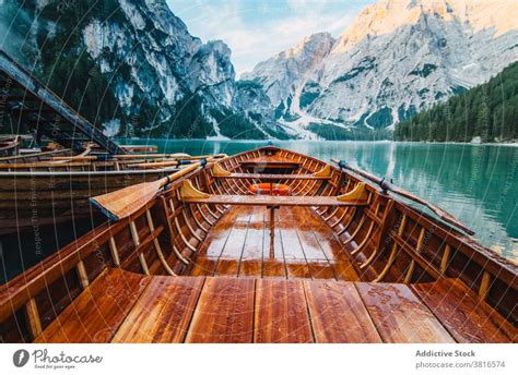 Wooden boat on clear lake in mountains - a Royalty Free Stock Photo from Photocase