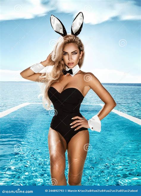 Blonde Model Dressed in Easter Bunny Costume and Bunny Ears is Standing