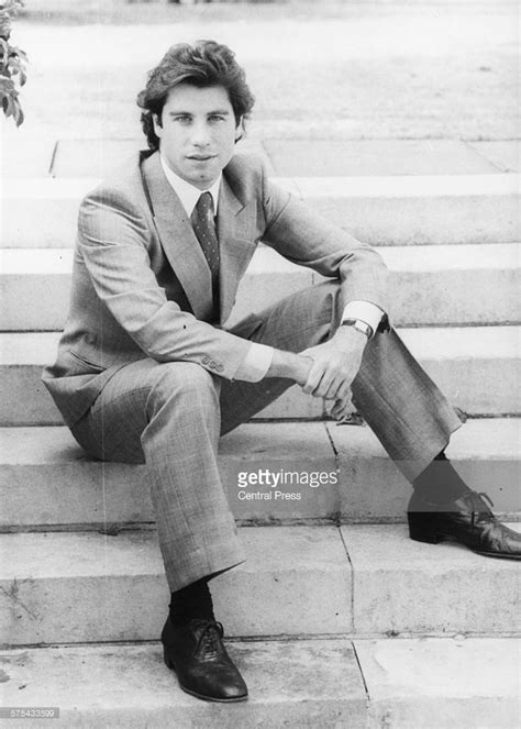 Portrait of actor John Travolta wearing a suit and tie and sitting on... | Actor john, John ...