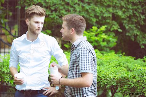 friends men talking standing   garden stock photo