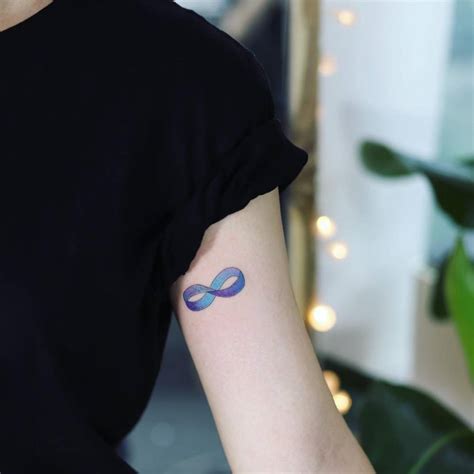 Möbius strip tattoo on the left inner arm.