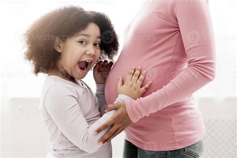 Excited Afro Girl Emotionally Reacting To Baby Moves In Her Mother's