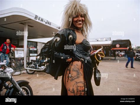 Biker woman showing tattoo on thigh during Bike Week in Daytona Beach ...