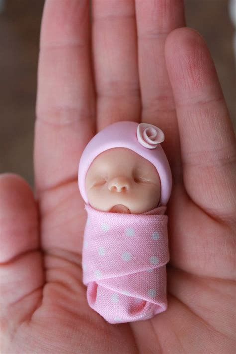 This listing is for one (1) hand sculpted polymer clay baby. She is 2