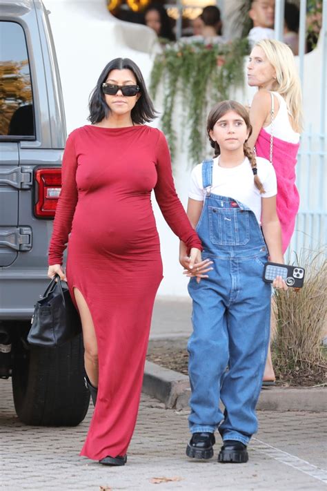Kourtney Kardashian goes braless in tight red dress & shows off her