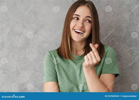 Happy Beautiful Nice Girl Rubbing Her Fingers and Smiling Stock Photo