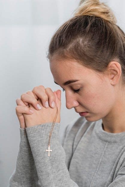 Free Photo | Young woman praying at home with cross necklace | Hand ...