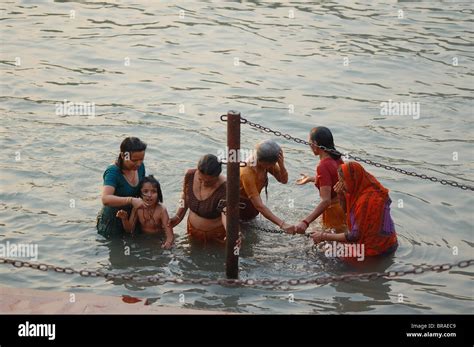 women bathing in holy river Ganges in India during Kumbh Mela festival ...